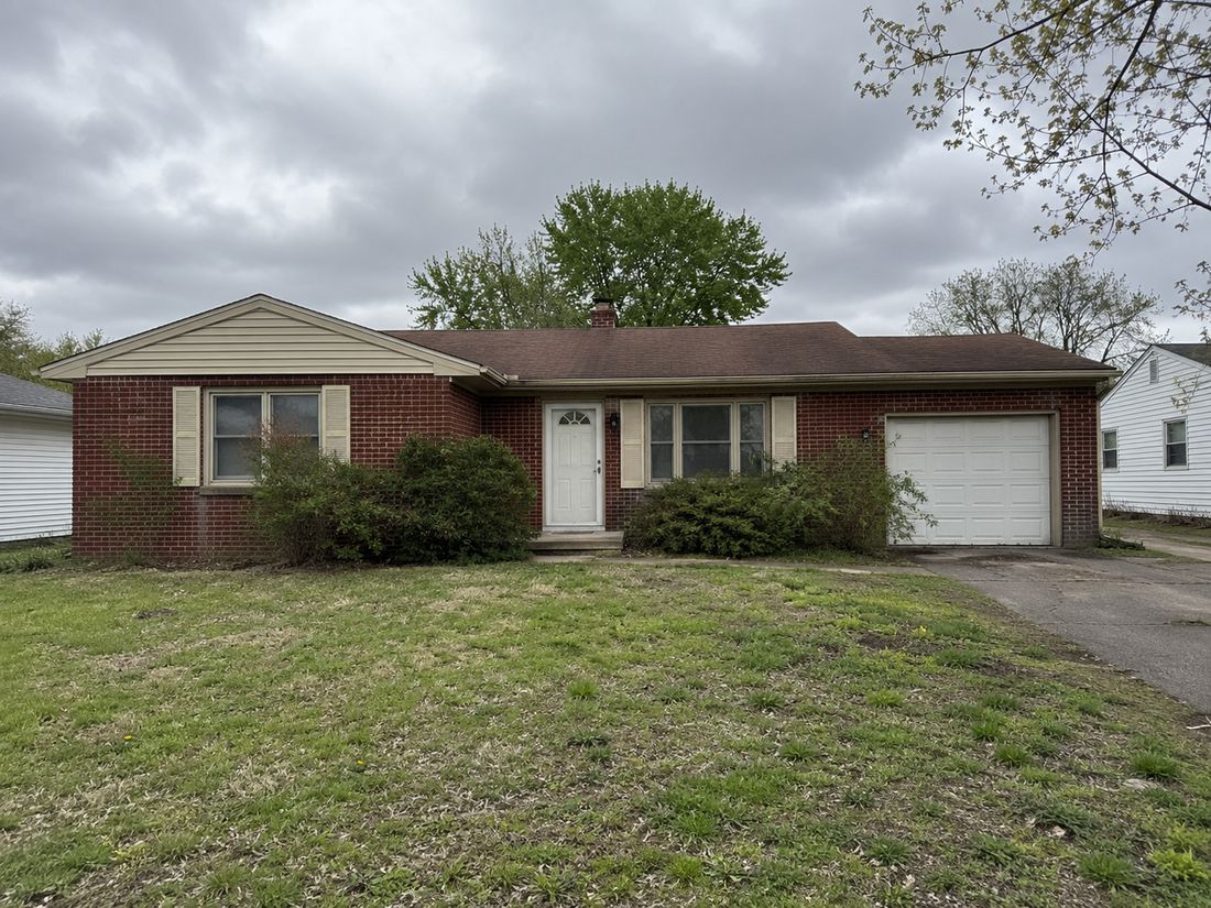 A brick ranch with an attached garage