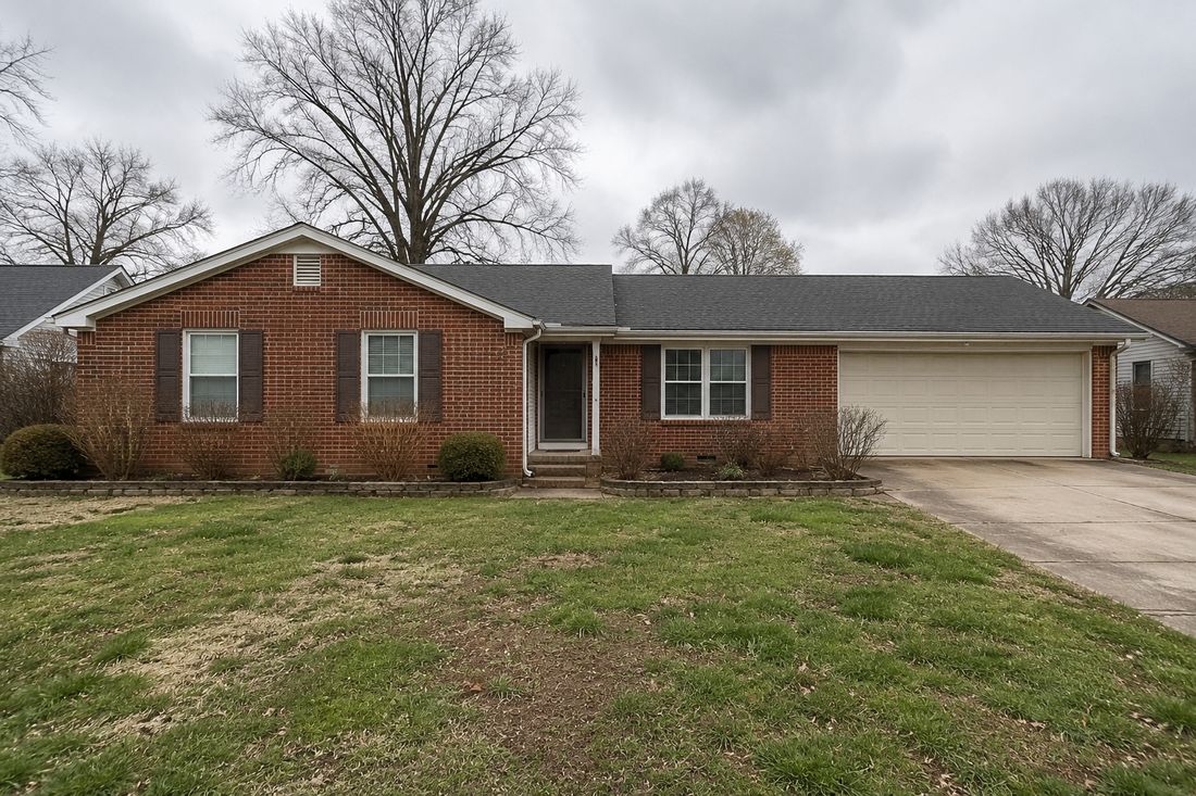 A brick ranch with a garage