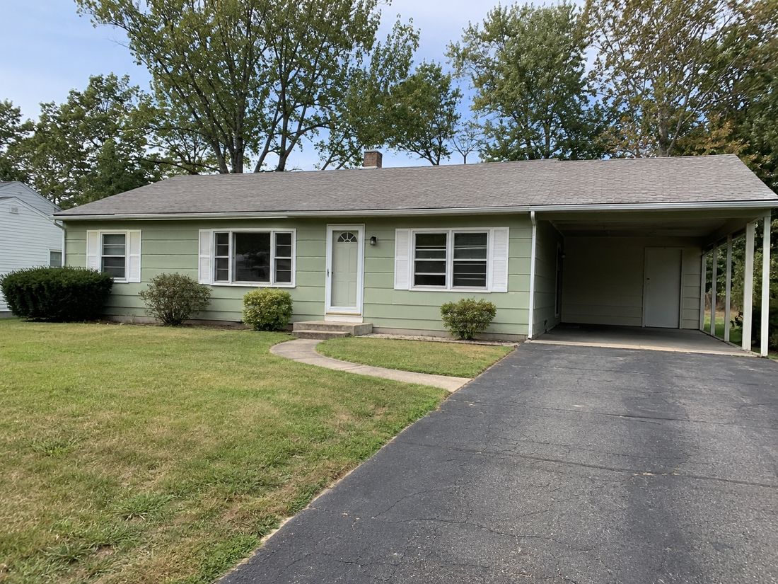 A ranch home with a carport