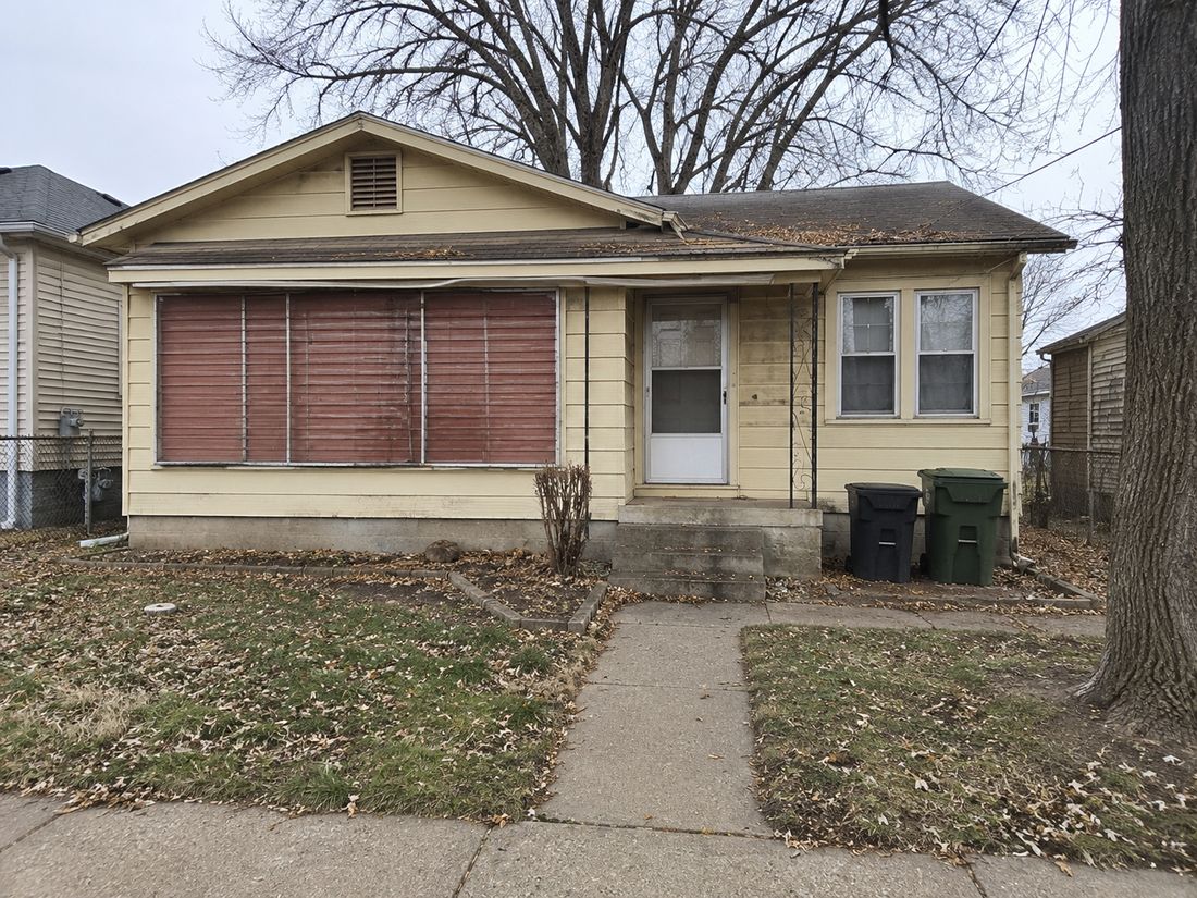 A small bungalow with an enclosed porch