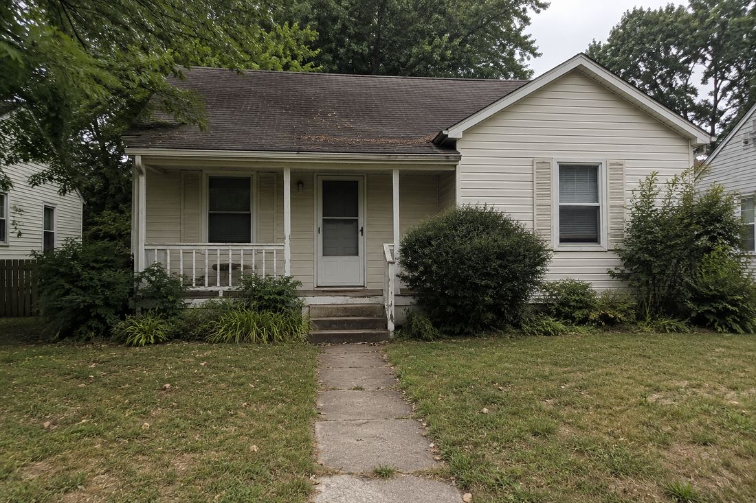 A small cottage with a front walkway